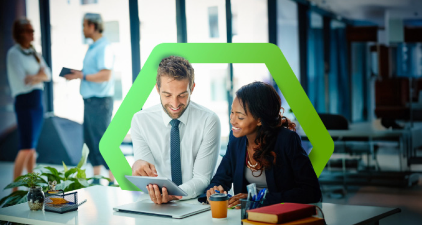Man and woman in office on a tablet surrounded by a hexagon