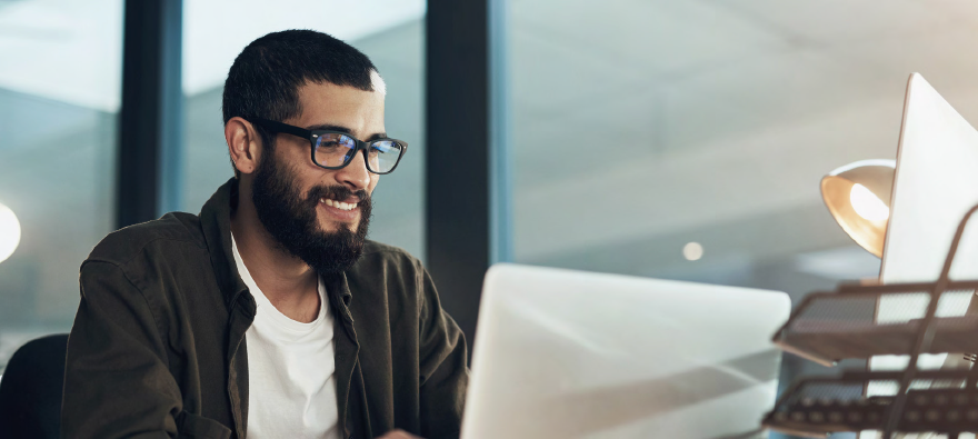 Man on laptop at office desk Man on laptop at office desk