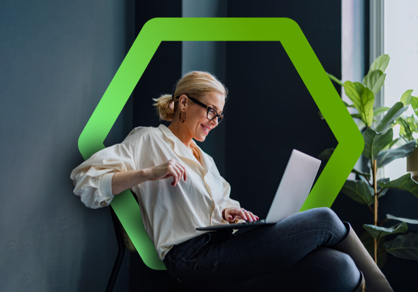 Woman in casual chair looking at laptop