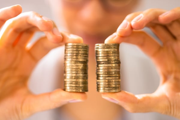 Two equal stacks of money to indicate pay equality