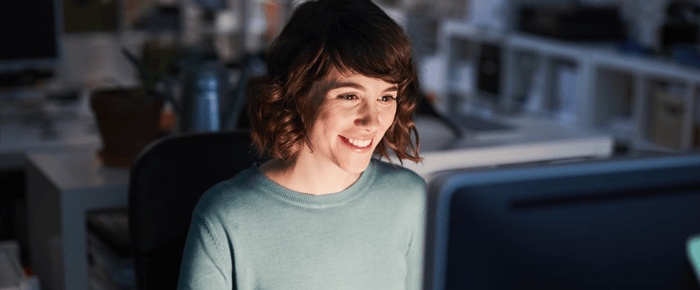 girl smiling at computer screen