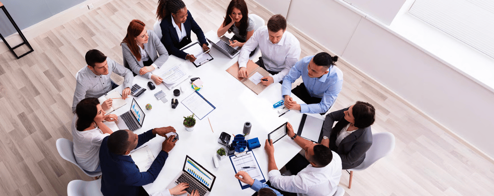 Aerial view of technology meeting in an office Aerial view of technology meeting in an office