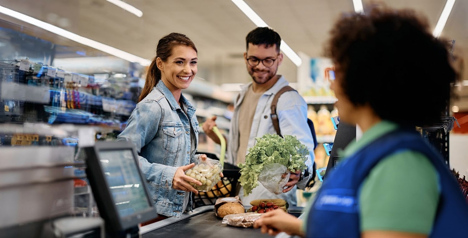 man and woman checking out at supermarket man and woman checking out at supermarket